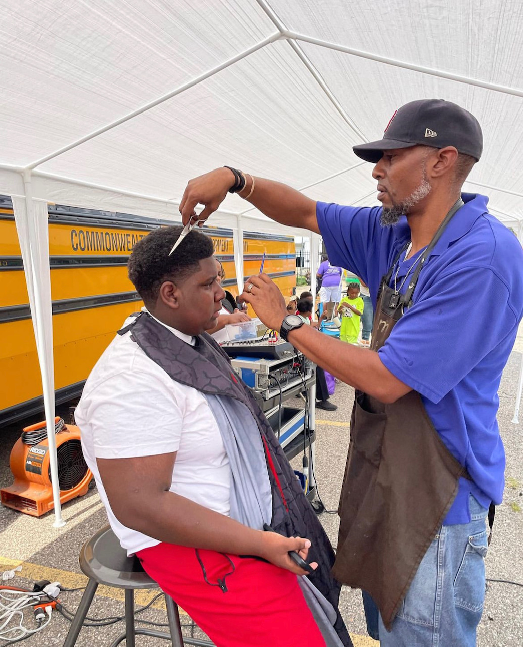 Young man getting a haircut outside